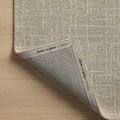 Corner of Polly Spa rug lifted to show branded underside with Chris Loves Julia x Loloi label