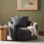 Side view emphasizing smooth curve of back and armrest with two pillows angled inside