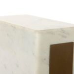 Corner detail of rectangular white marble base showing smooth finish and bronze mounting plate