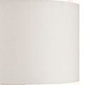 Off-white drum shade close-up showing fabric texture and matching finial detail on top