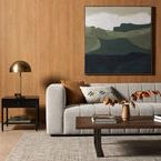 Living room setting with grey Nador rug underneath sofa, coffee table, side table, and large landscape artwork