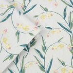 Rolled wallpaper showing close-up details of floral print and texture on light background