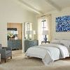 Sara 9-Drawer Cabinet styled in a bedroom with neutral bedding, blue accents, and natural light
