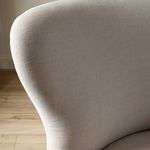 Bright room setting showing Omar Chair with textured linen fabric and modern accents