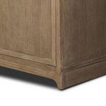 Close-up on base corner construction with curved foot detail and oak wood texture