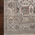 Side angle view showing thin profile and texture of rug edge and fringe