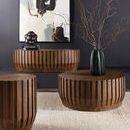 Styled room scene with Gears Oval Cocktail Table paired with two matching side tables on a textured rug