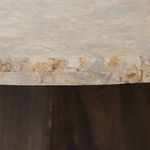 Tight close-up of onyx tabletop edge showing thickness and mixed earthy tones