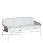 Angled side view of sofa highlighting cane side panels with white frame and plush white cushions