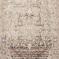 Theia Taupe / Brick Rug with neutral tones and subtle pops of brick and blue, intricate patterns with a refined fringe border