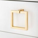 Detail of square gold drawer pull mounted on white lacquered linen drawer front
