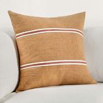 Pillow styled on a light gray sofa showing scale and how it complements neutral decor