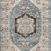 Traditional rug with a blue central medallion and beige borders featuring intricate vintage Turkish Oushak motifs