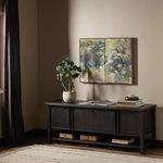 Dalton Media Console in living room setting under abstract wall art with decorative items on top