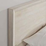Angled close-up of headboard corner emphasizing smooth edges and light wood grain