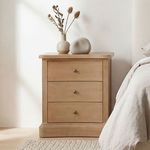 Clarence Nightstand styled in bedroom with vase and stone decor on top next to neutral-toned bed