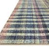 angled close-up of rug edge showing low profile on white background