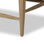 Close-up of tapered oak leg with connecting support bars beneath Godfrey Chair