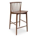 Three-quarter front angle showing tapered legs and footrest bars of walnut counter stool