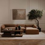 Casey Coffee Table centered in stylish living room with brown suede sofa, large art, and olive tree
