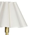 Close-up of white scalloped shade texture on brass lamp