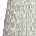 Close-up showing green and white pleated fan-patterned fabric texture on lamp shade