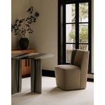 Cormac chair placed in dining room with marble table and large window in natural light