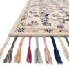 Side view of Elka Ivory Multi Rug showing soft pile and color-varied braided tassels in detail