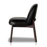 Right side profile showing smooth black leather seat and back on dining chair with dark wood legs