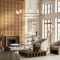 Wide room context showing chandelier with tan shades above modern living space with wood accents