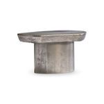 Angled side view displaying the round base supporting the free-flowing tabletop in graphite