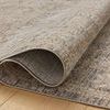 Curled edge of rug highlighting flexible texture and low pile on hardwood floor