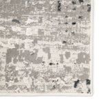 Detailed zoom on rug texture highlighting low and high pile areas in gray and ivory shades