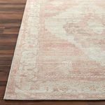 Detailed close-up of Luca Rug corner showing finished edge and low-profile weave on wood floor