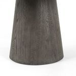 Bottom close-up of tapered oak table base highlighting wood grain and texture against white background