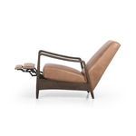 Styled living room setting with olive green leather recliner extended and wooden sideboard in background