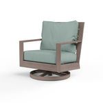 Laguna Swivel Club Rocker outdoor chair with hand-brushed driftwood aluminum frame and light blue cushioned seat and back