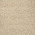 Natural wool area rug with ribbed high-low pile showing subtle traditional motifs in beige tones
