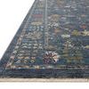 Close-up showing the low pile texture and fringed edge of the denim blue rug with floral pattern