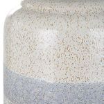 Macro detail of ceramic lamp base showing textured speckled surface and color gradient from cream to gray
