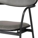 Close-up of the stool’s curved backrest and padded gray seat cushion with matte black frame details