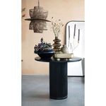 Dining table adorned with decorative vases and plants under woven pendant lighting with modern art in background