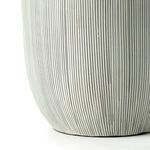 Close-up of lamp base highlighting slender vertical stripes and matte finish.