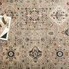 Close-up of Leigh Dove rug with decorative books and coaster highlighting texture and color details