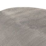 Oblique close-up view of table edge and smooth textural details of base
