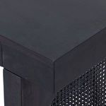 Close-up corner view of thick black wash mango wood top and side panel on Tilda desk