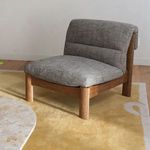 Pierce Accent Chair placed on yellow rug near marble coffee table and patterned sofa in living room