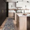 long runner version of the navy multi Giada rug in a modern kitchen with light wood cabinetry and black accents