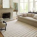 Chris Ivory Slate Rug in living room with beige sofa, armchair, fireplace, and natural light