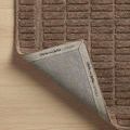 Rug corner flipped up revealing branded fabric backing with Chris Loves Julia x Loloi text